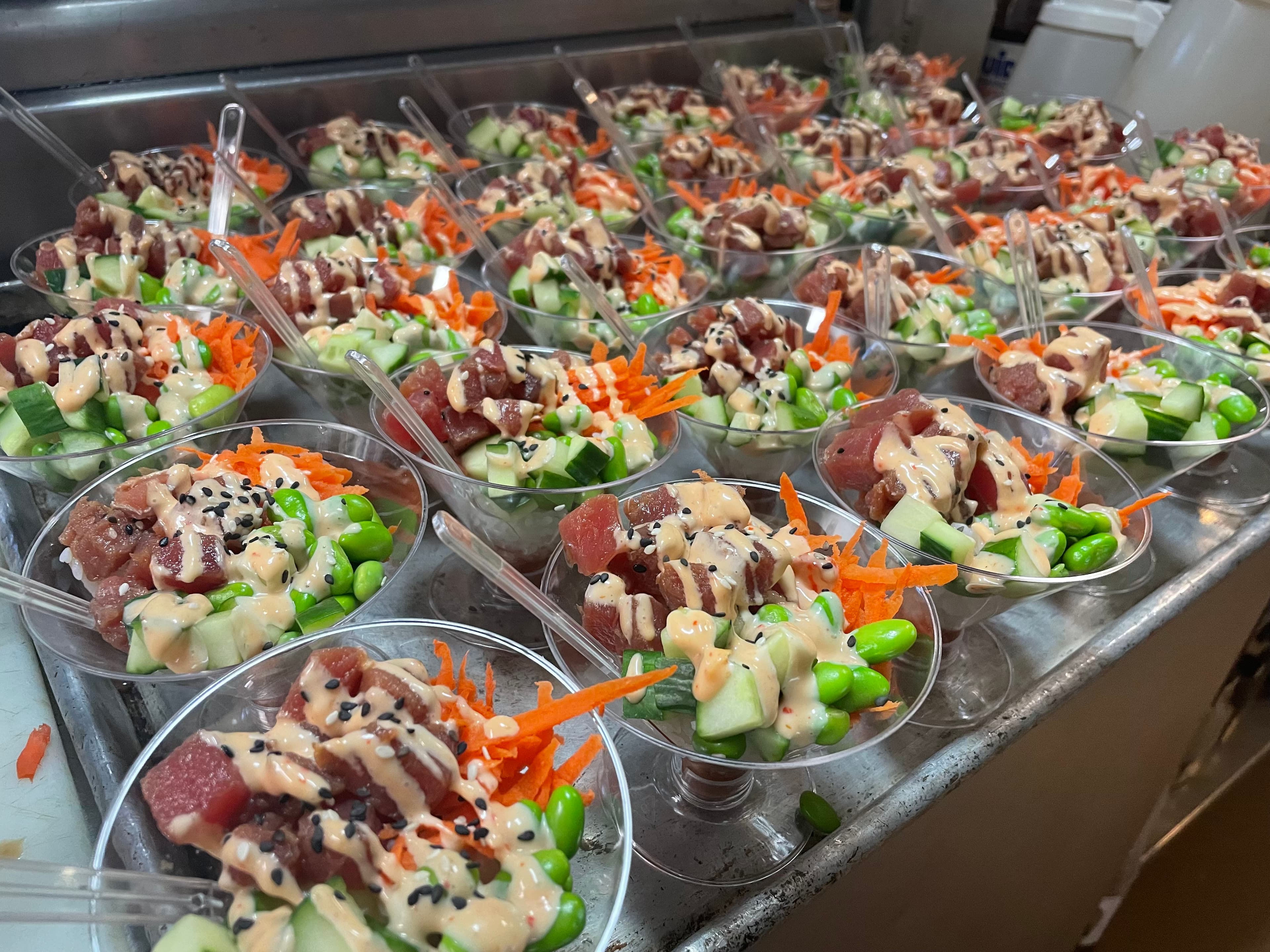 Ahi poke cups plated for a catering event